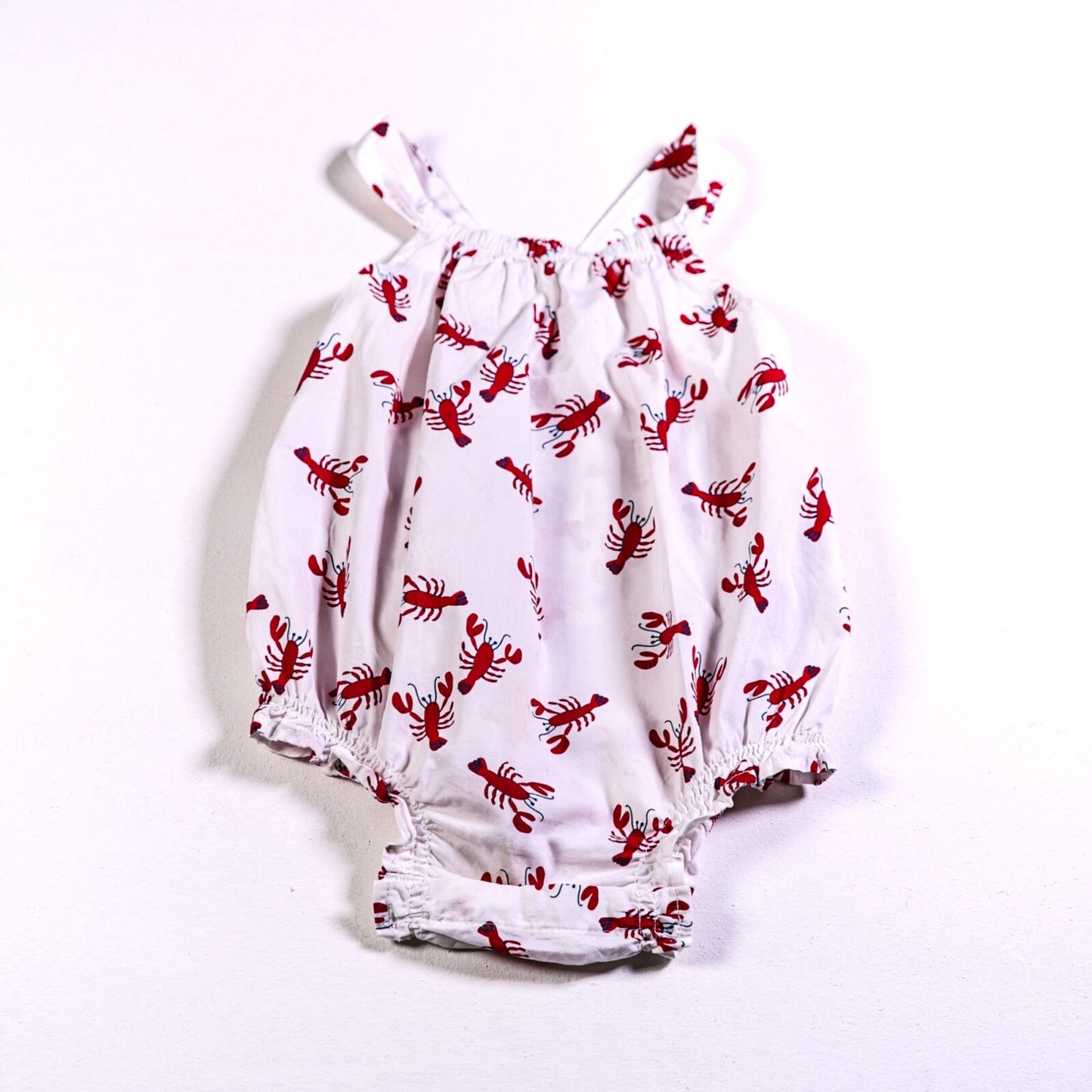 Cotton bloomer romper with lobster print and frilled back. (stained)